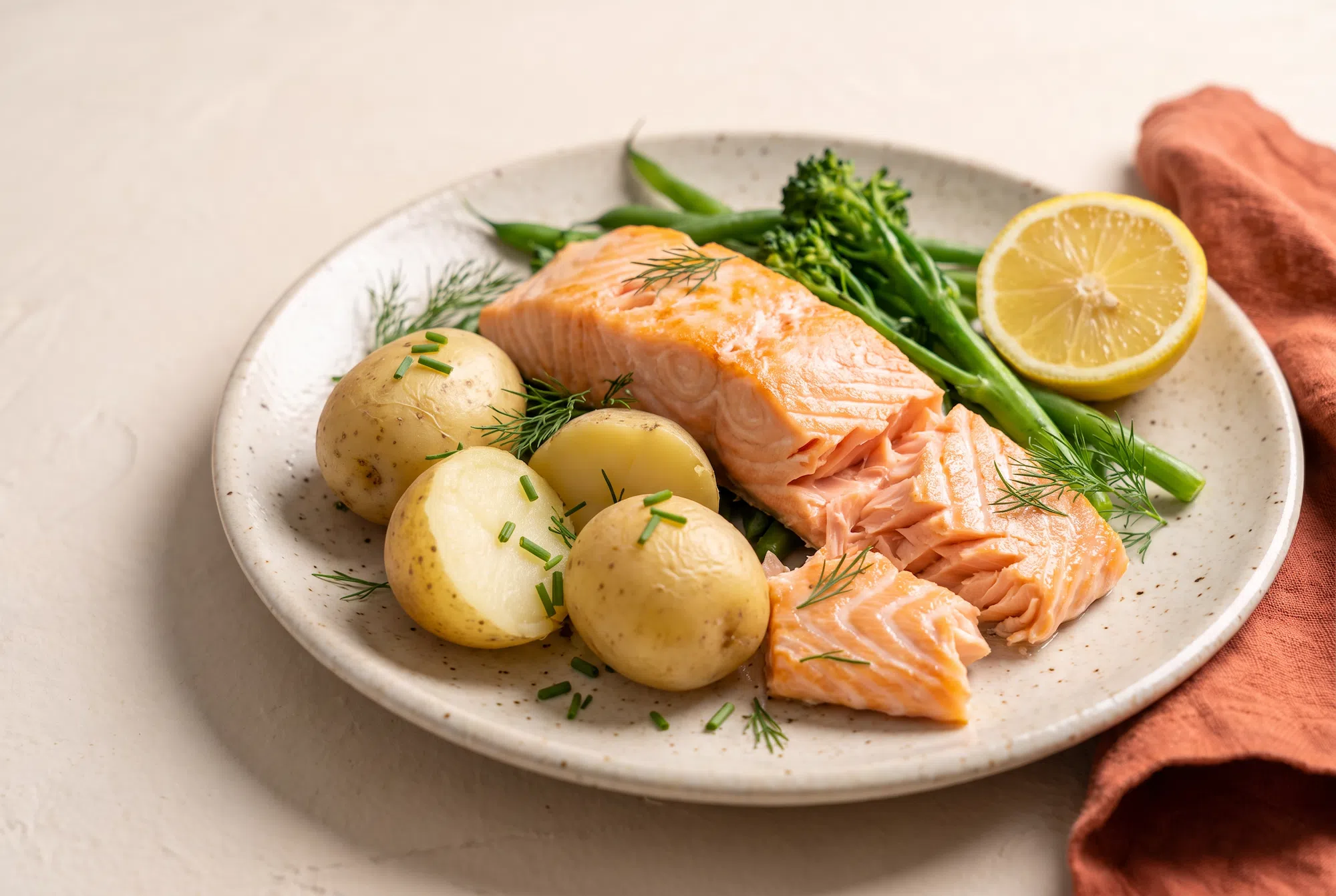 Baked salmon with new potatoes, tenderstem broccoli and green beans, an example dinner while taking GLP-1 medication
